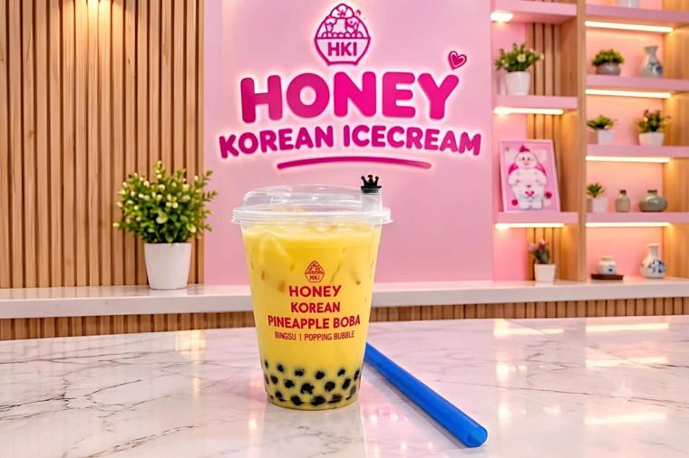 Pineapple boba in a Honey Korean Icecream cup on a marble counter